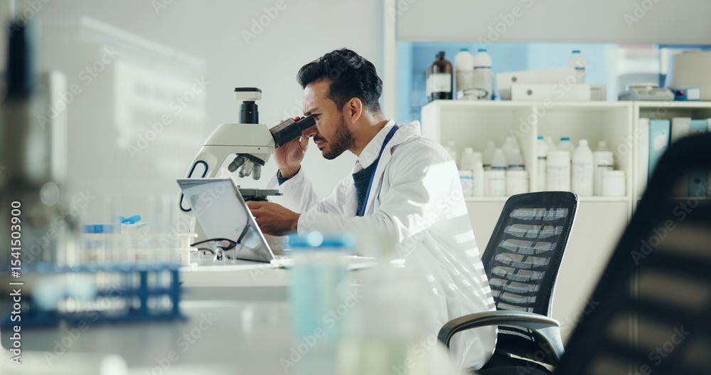 man with microscope in lab for clinical trial