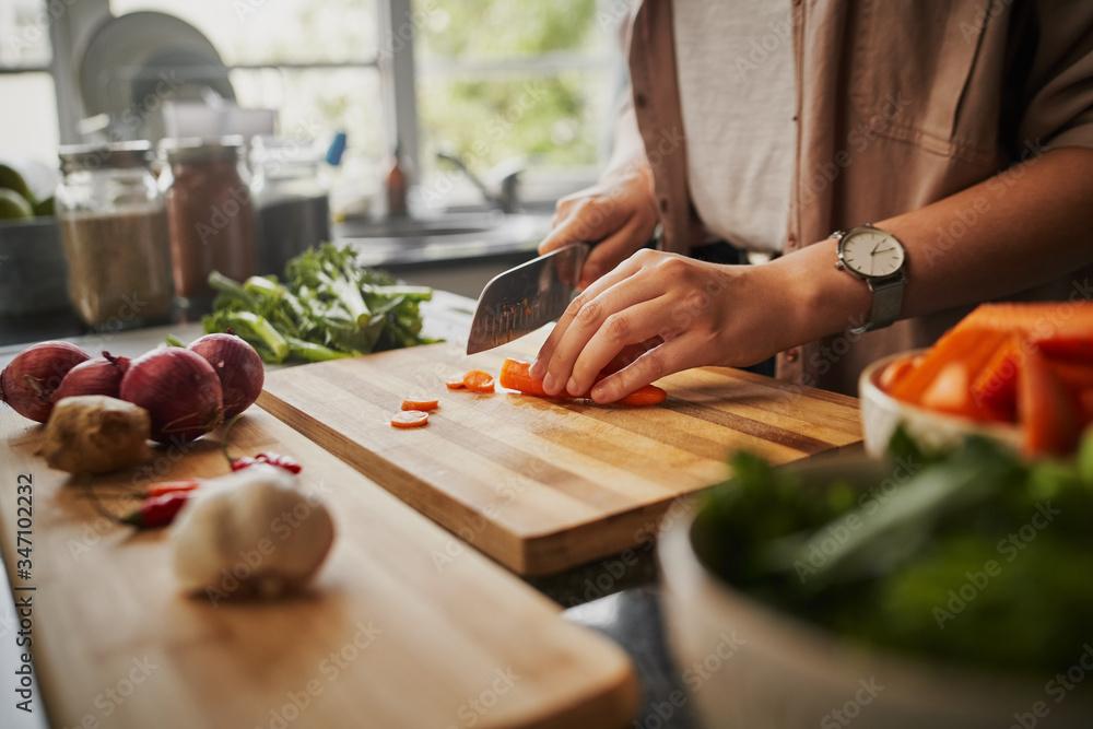 person chopping carrots