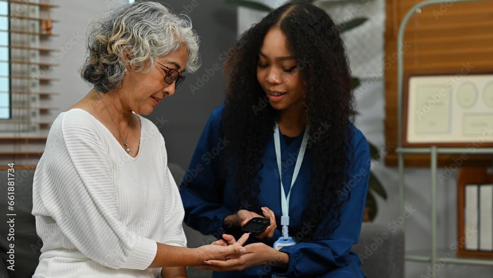 nurse and elderly patient checking blood sugar level