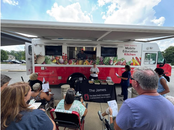 An OSU healthy cooking demonstration from a mobile food truck in front of an audience.  In collaboration with the James Mobil kitchen