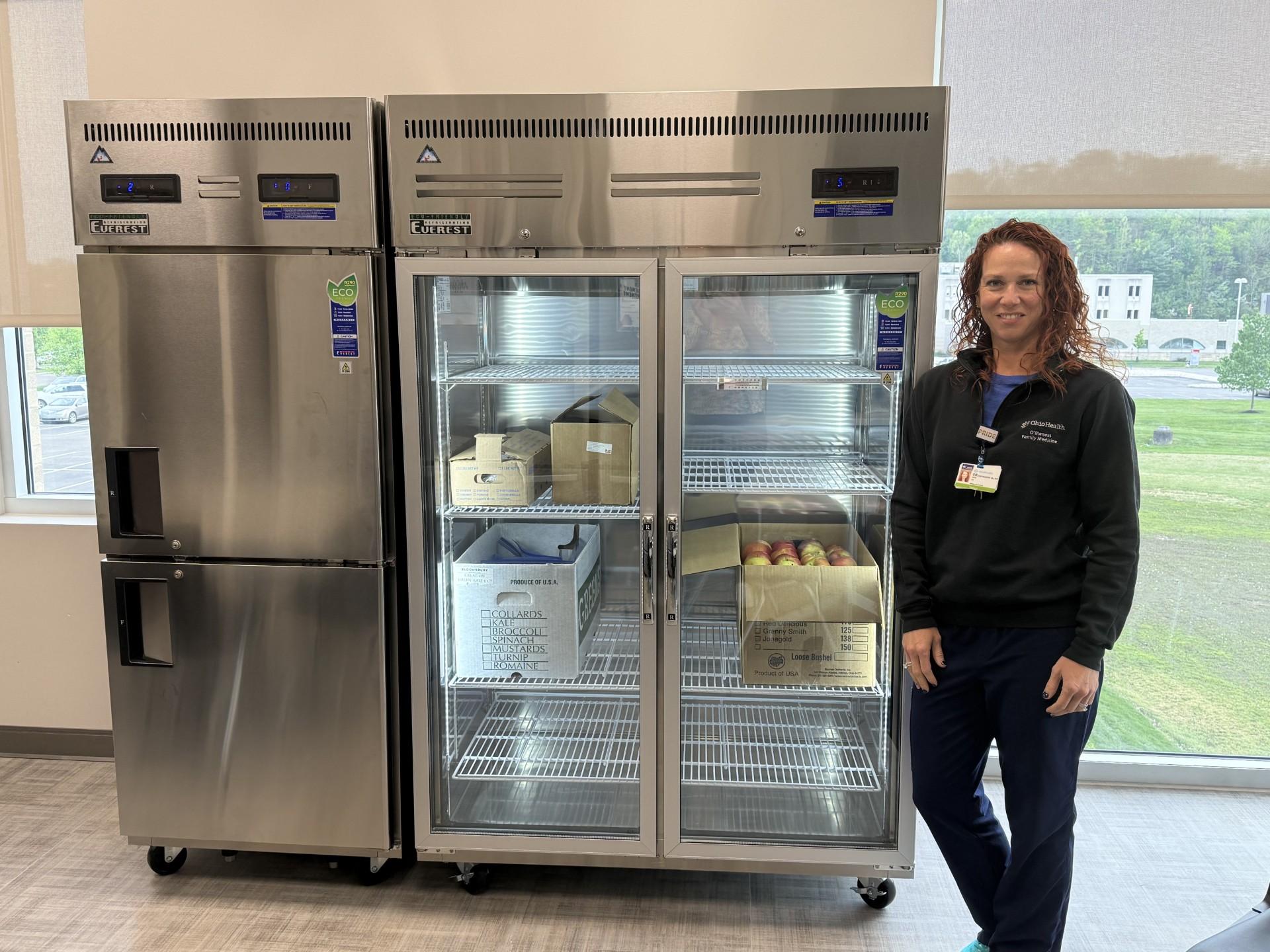 An OU representative standing next to a refrigerator that supports the Food RX program