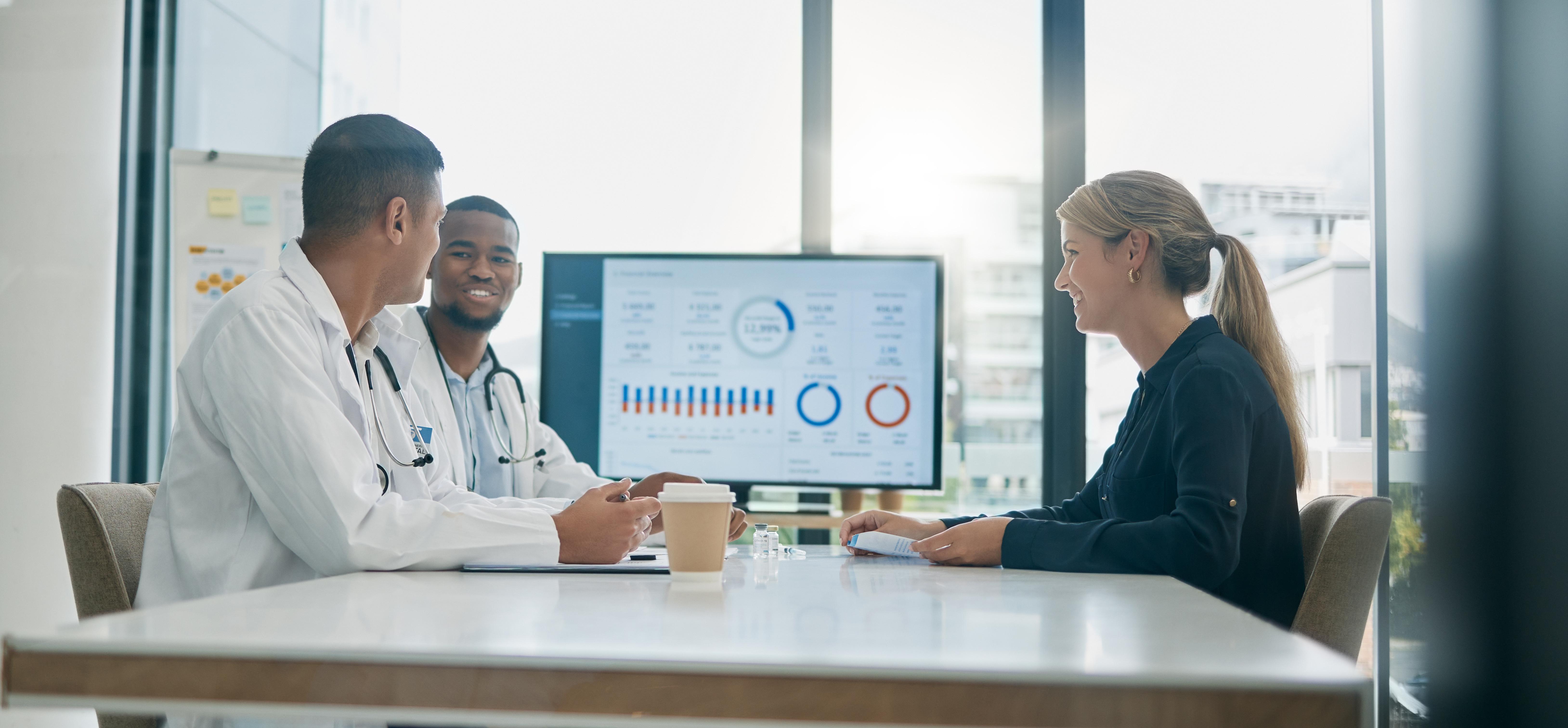 Team of doctors meeting with charts and graphs
