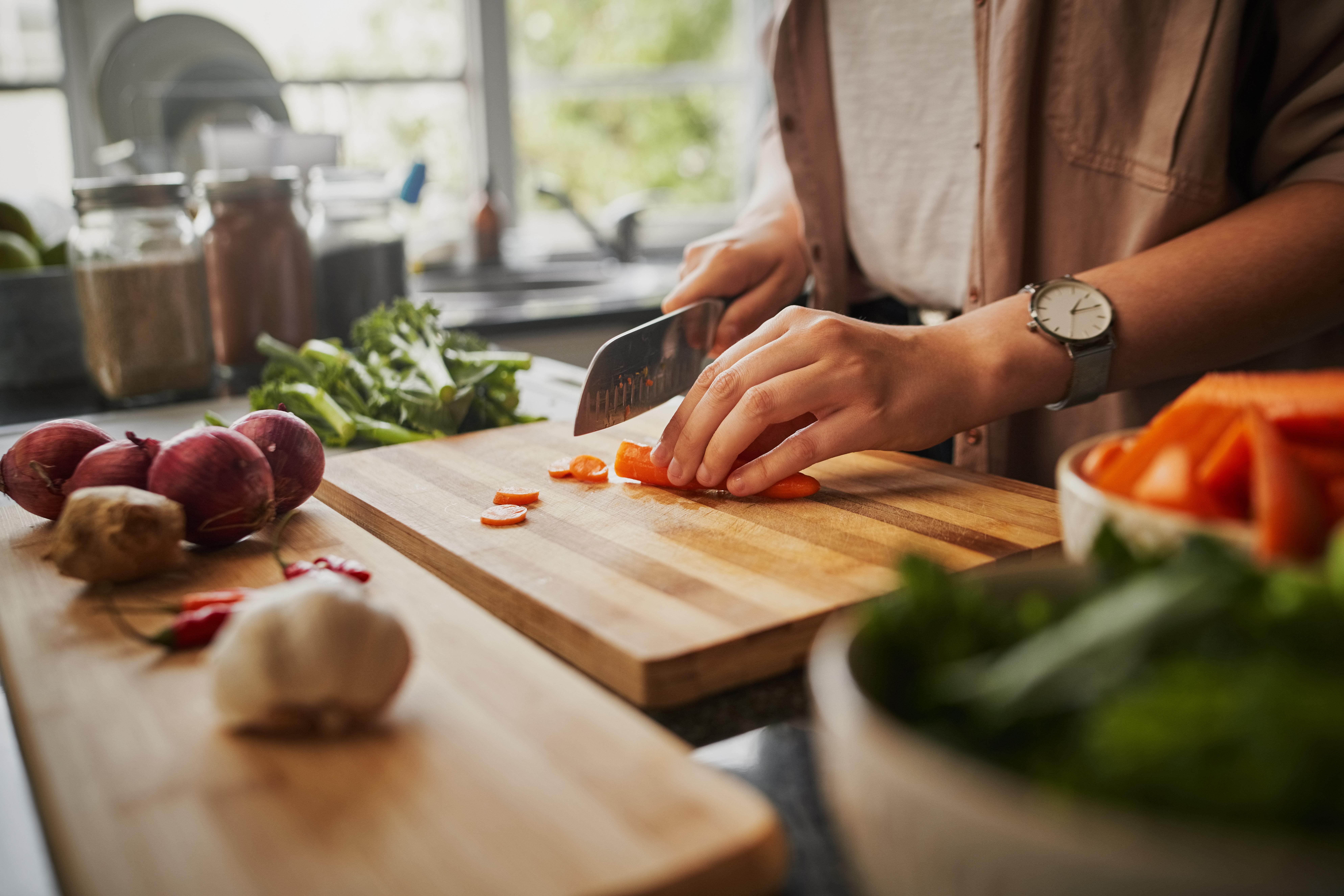 person chopping carrots